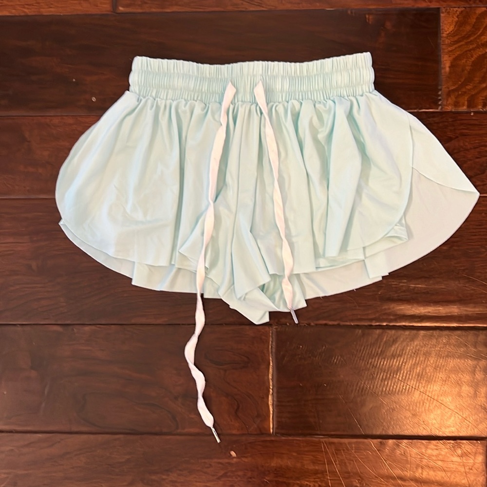 Aqua-colored athletic butterfly shorts with spandex underneath.